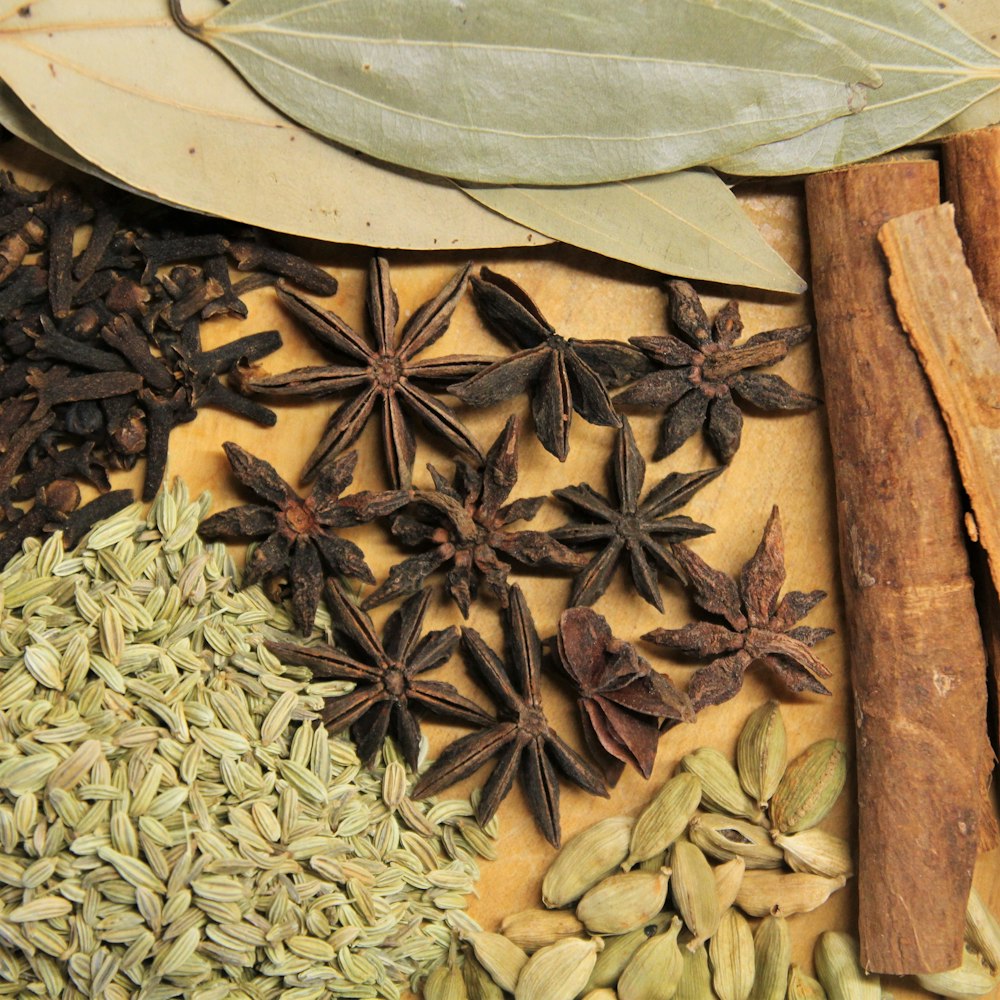 brown and black leaves on brown wooden surface