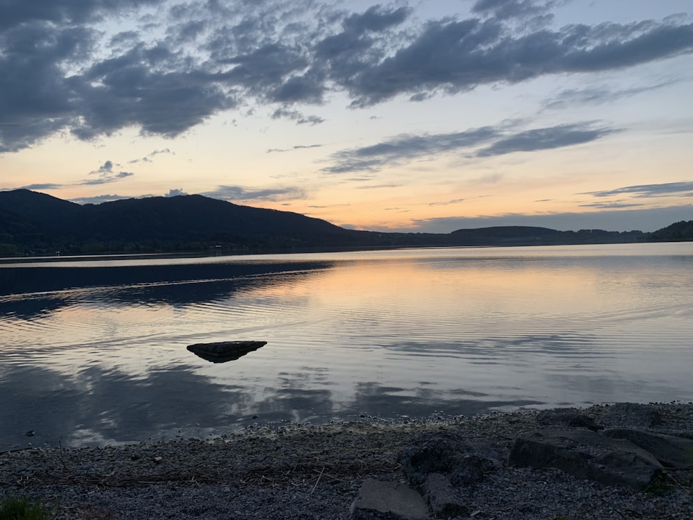 body of water under cloudy sky during daytime