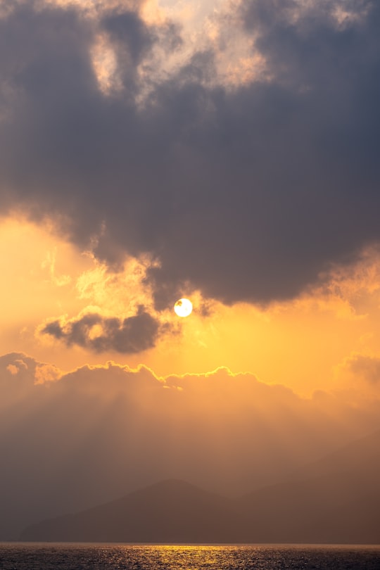 sun covered by clouds during sunset in Oedo South Korea