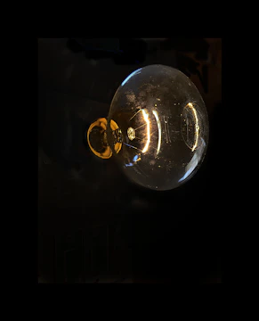 Close-up of a glowing vacuum tube with intricate filaments inside.