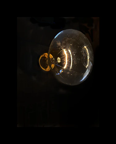 Close-up of a high-quality LED bulb with visible filament detail against a dark background