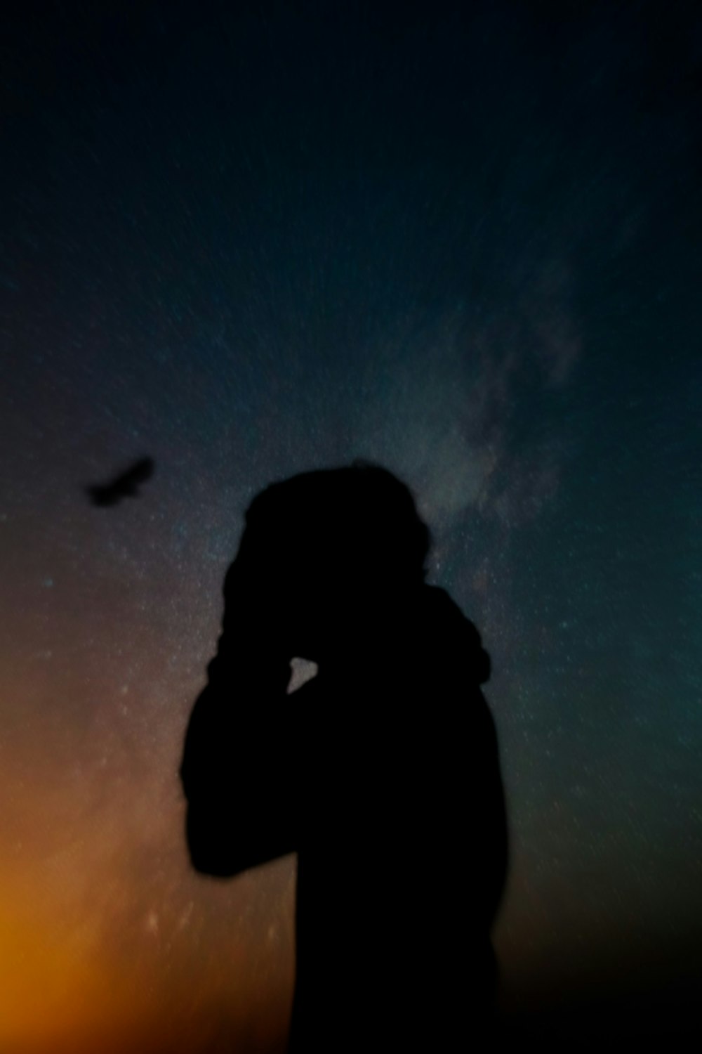 silhouette of man under blue sky