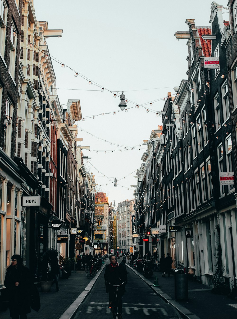 people walking on street between buildings during daytime