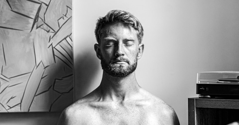 topless man in grayscale photography