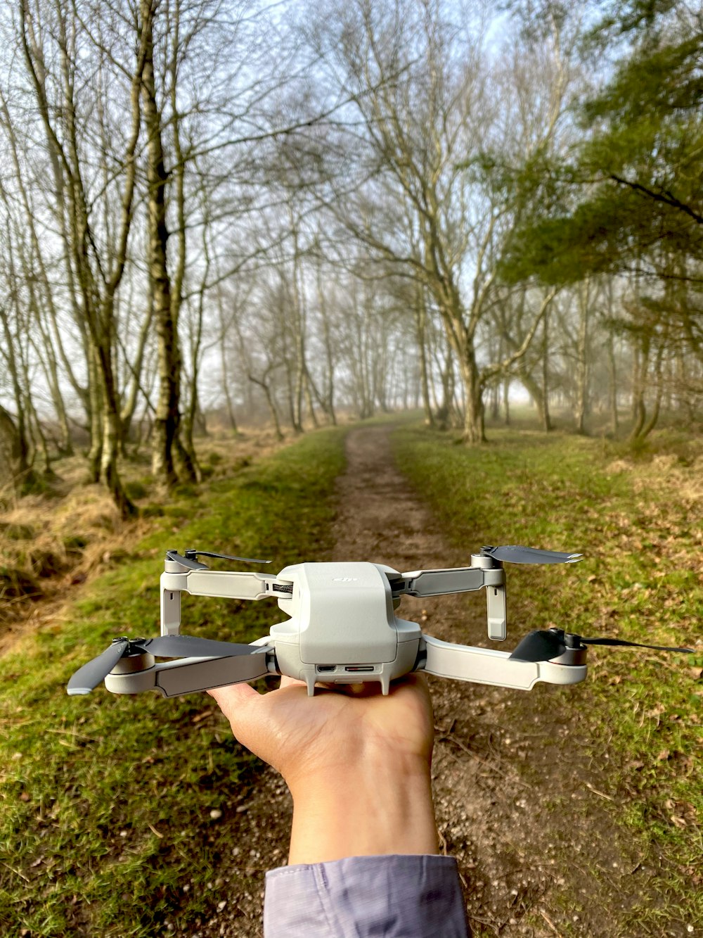 white and black drone in mid air during daytime