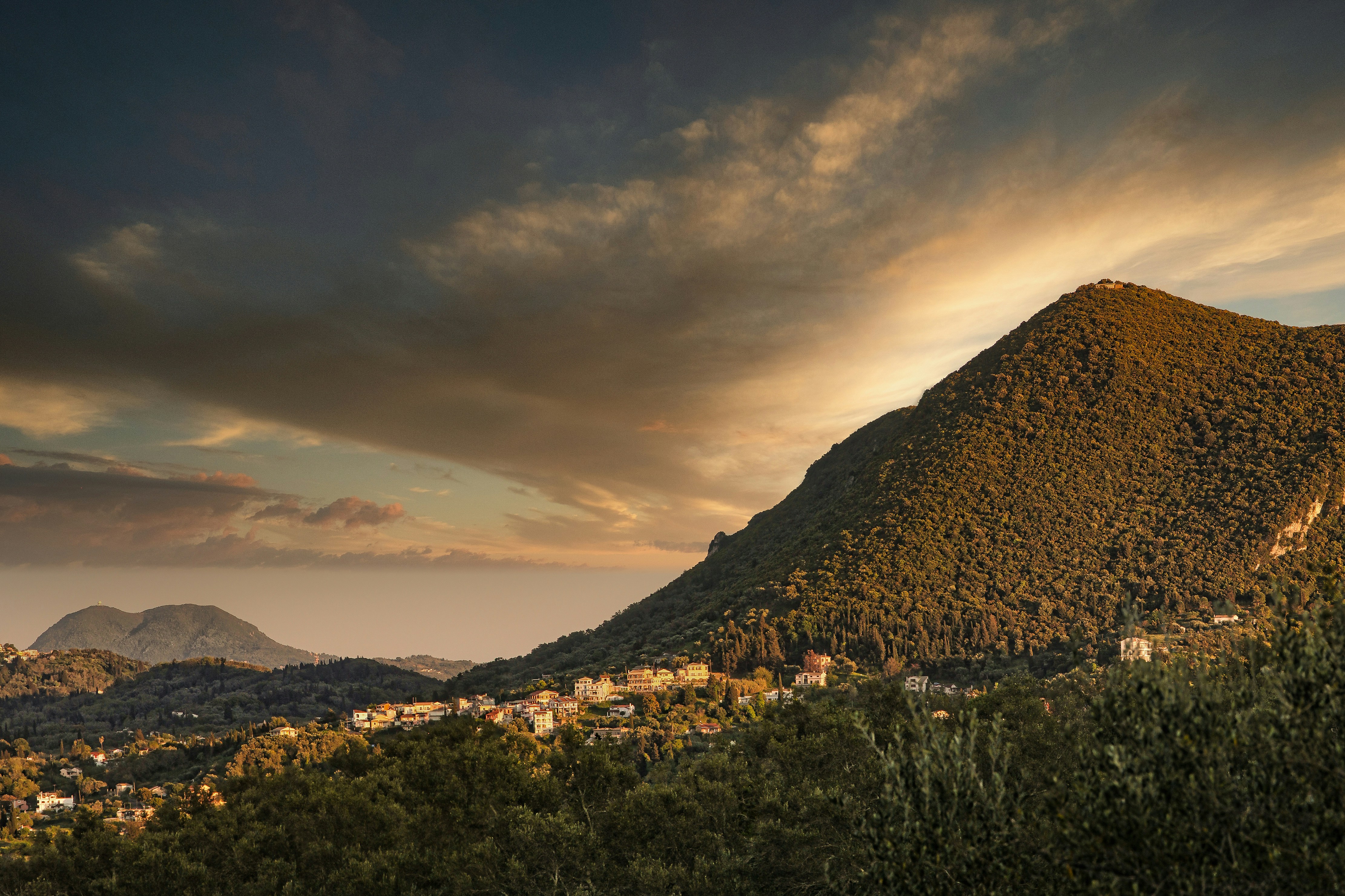 green grass field near mountain during daytime