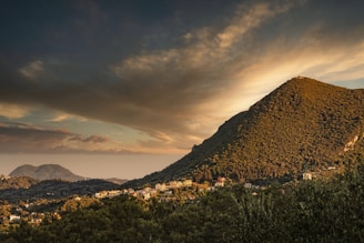 green grass field near mountain during daytime