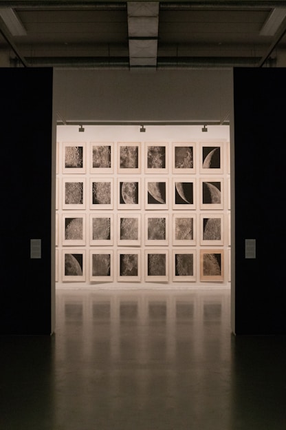 A close-up of a miniature grid of oil paintings with rich textures and muted colors.