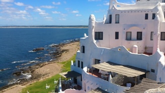 white concrete building near sea during daytime