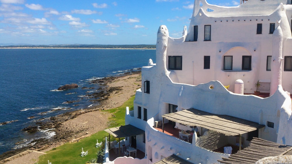 white concrete building near sea during daytime