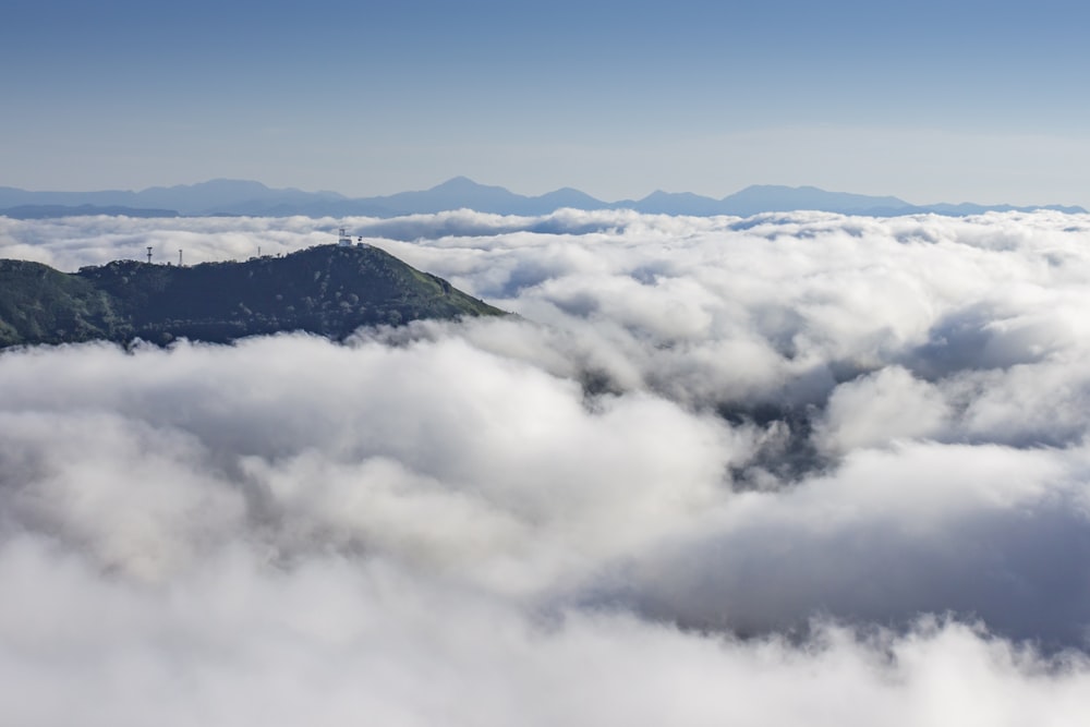 white clouds over green mountains