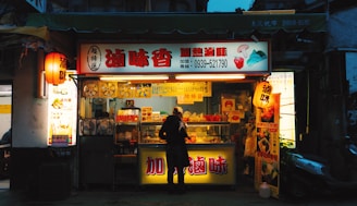 Photo of a colorful street food stand with various snacks and drinks displayed.