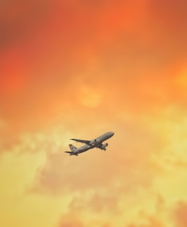 white airplane flying in the sky during daytime