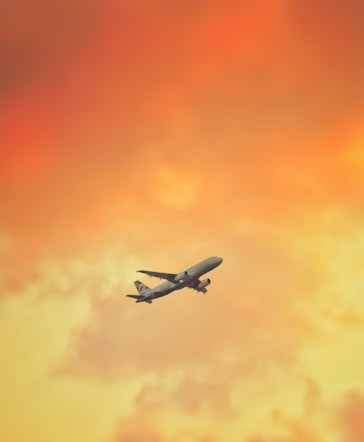 white airplane flying in the sky during daytime