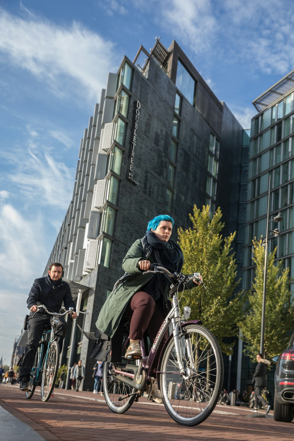 man in black jacket riding on bicycle