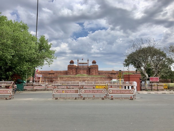 Historic photo of the Red Fort in Delhi, showcasing its majestic red sandstone walls under a clear sky.
