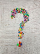 multi colored beaded necklace on brown wooden table