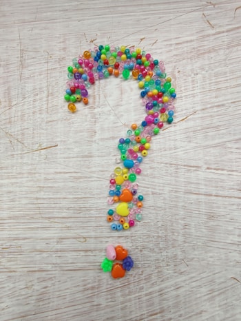 multi colored beaded necklace on brown wooden table