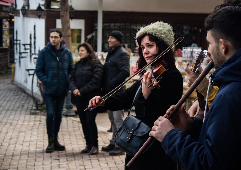 man in black jacket playing violin