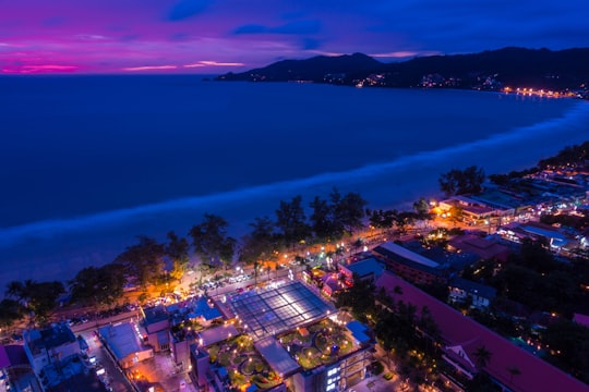 city with high rise buildings near body of water during night time in Phuket Thailand