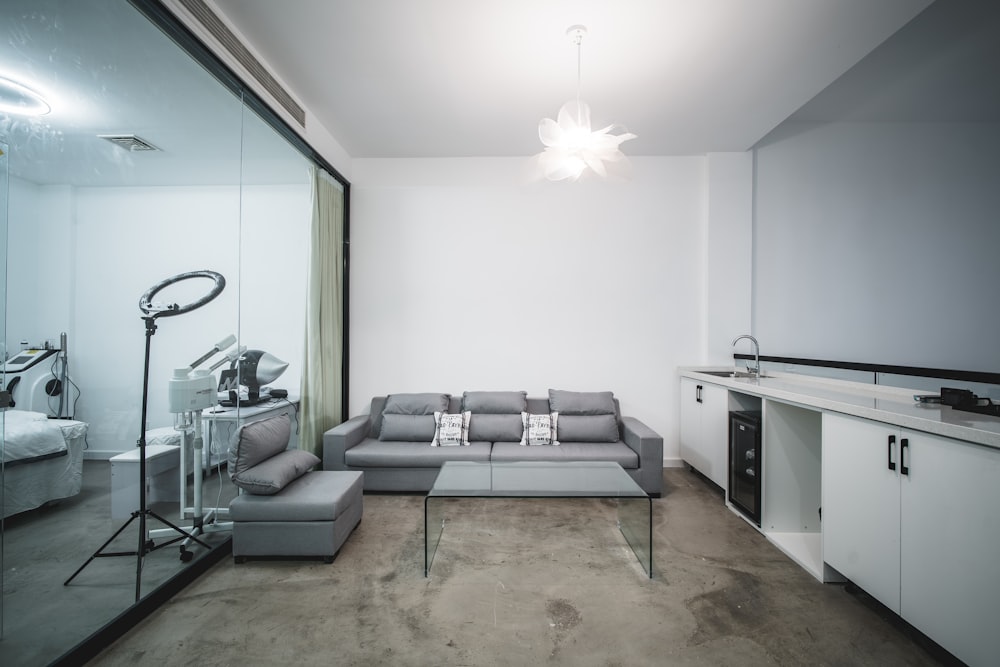 gray sectional couch beside white wooden table