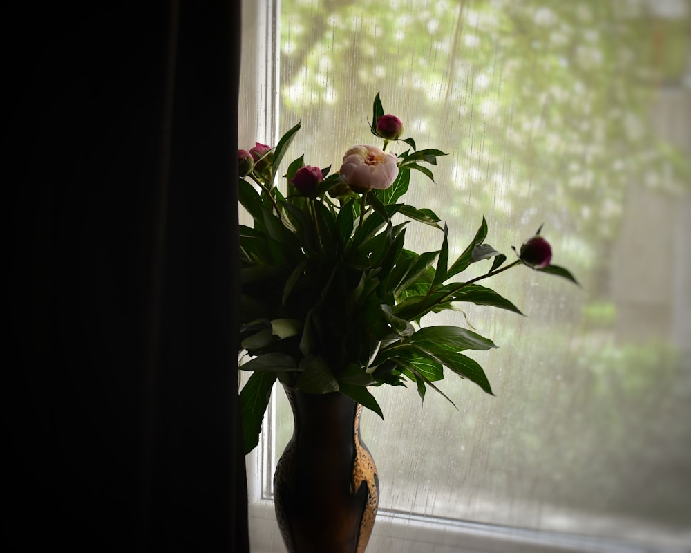 red flowers on brown ceramic vase