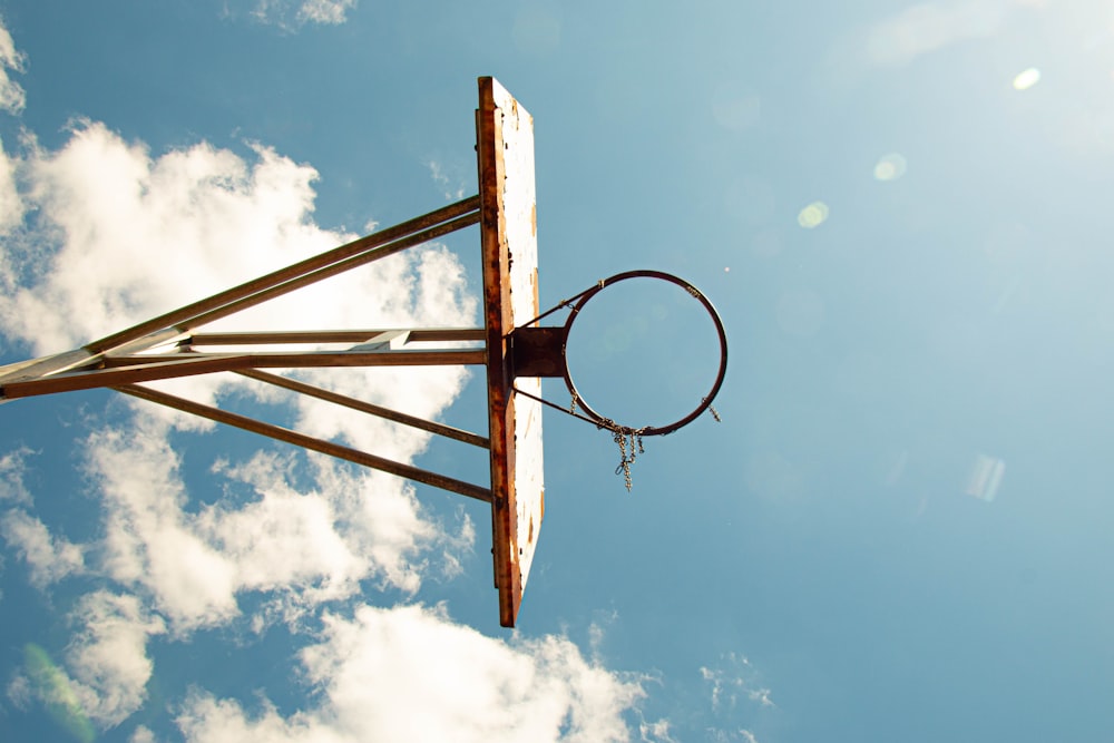 brown wooden basketball hoop under blue sky during daytime