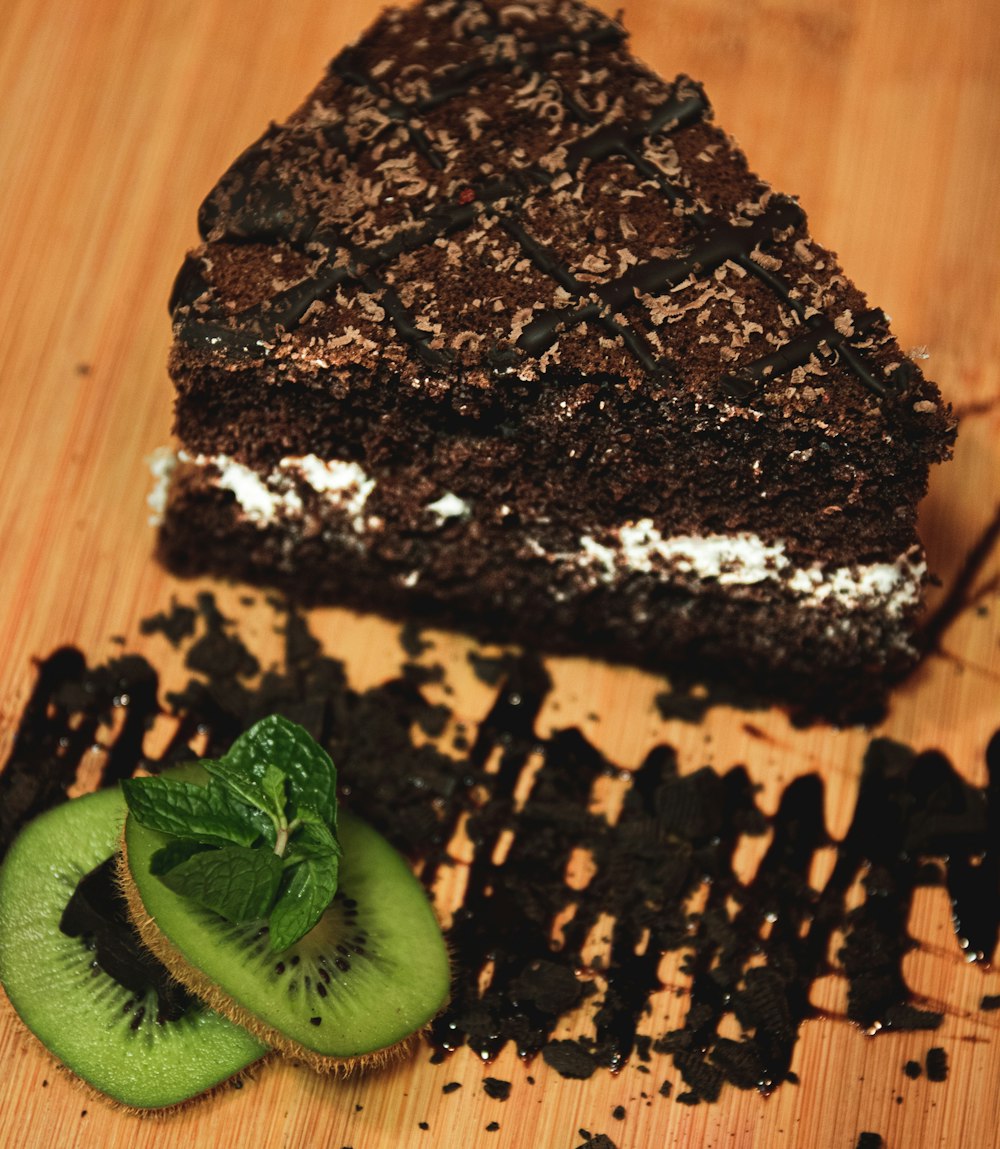 sliced green fruit on chocolate cake