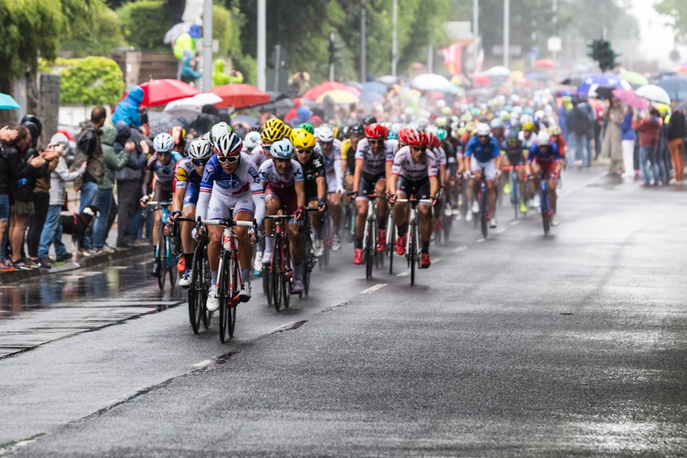 people riding bicycle on road during daytime