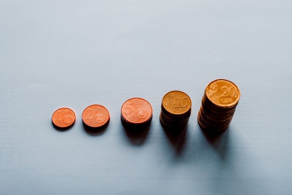 eight round gold coins on white surface