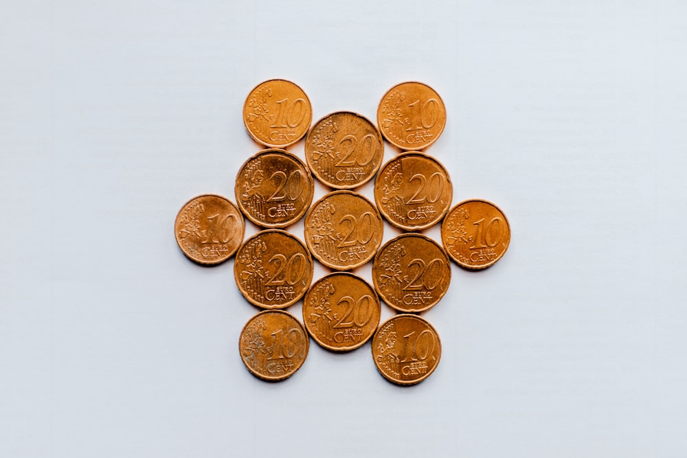 gold round coins on white surface
