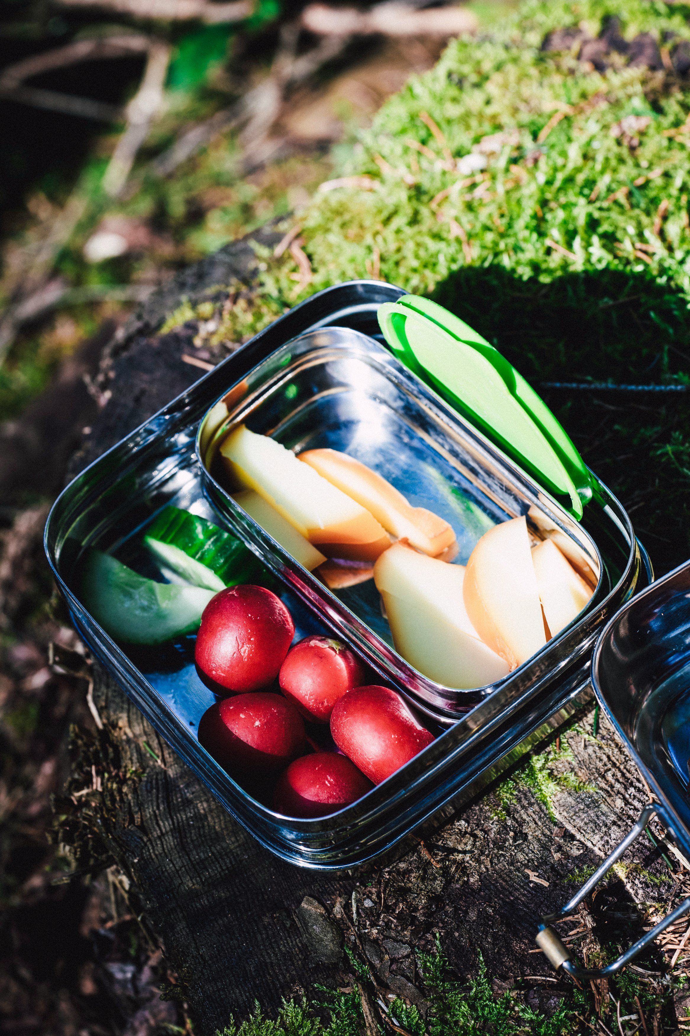 red and white fruits in green plastic container