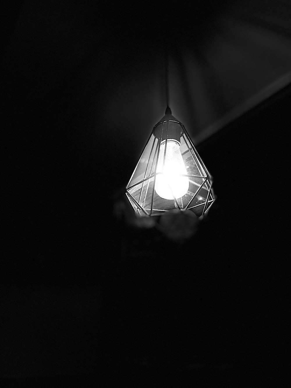 white pendant lamp turned on in dark room