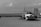 grayscale photo of a truck on a field