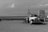 grayscale photo of a truck on a field