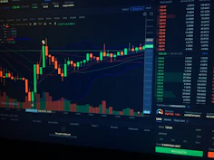 A digital candlestick chart showing cryptocurrency market trends on a dark computer screen