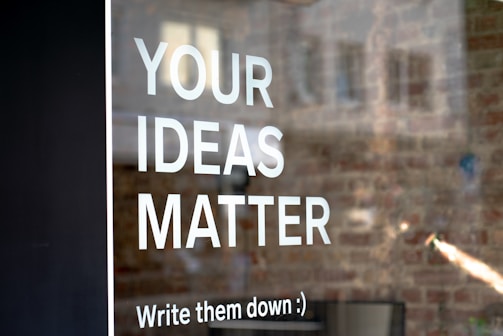Sign on window reads; "Your ideas matter, write them down"