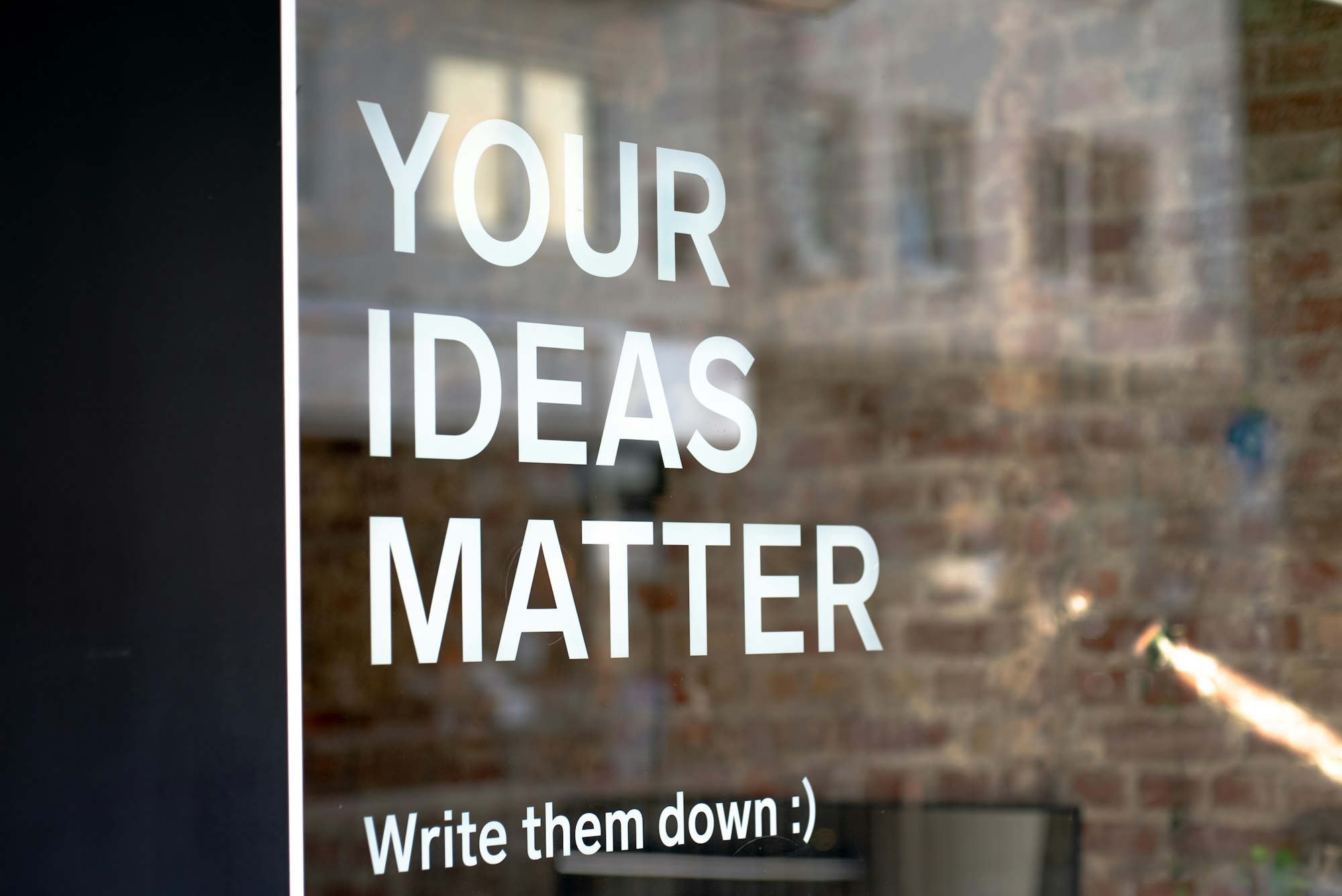 Your Ideas Matter! 
Write them down :)
A motivational quote on a coworking space.