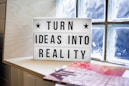 white and black wooden quote board