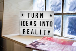 white and black wooden quote board