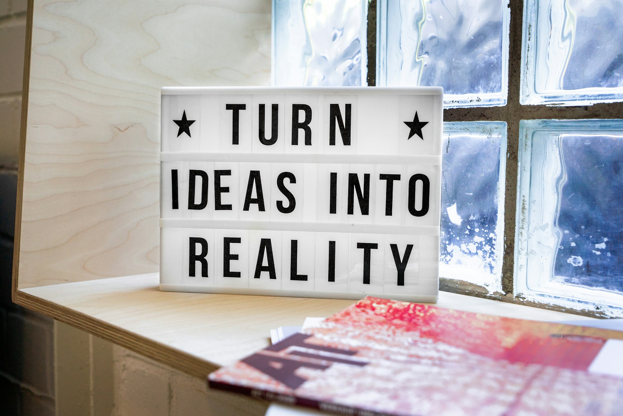 Turn Ideas into Reality! A motivational sign in a Co-Working Space. 