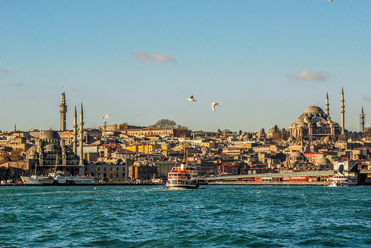 A ferry crossing the Bosphorus with the skyline of Eminönü, Istanbul, in the background