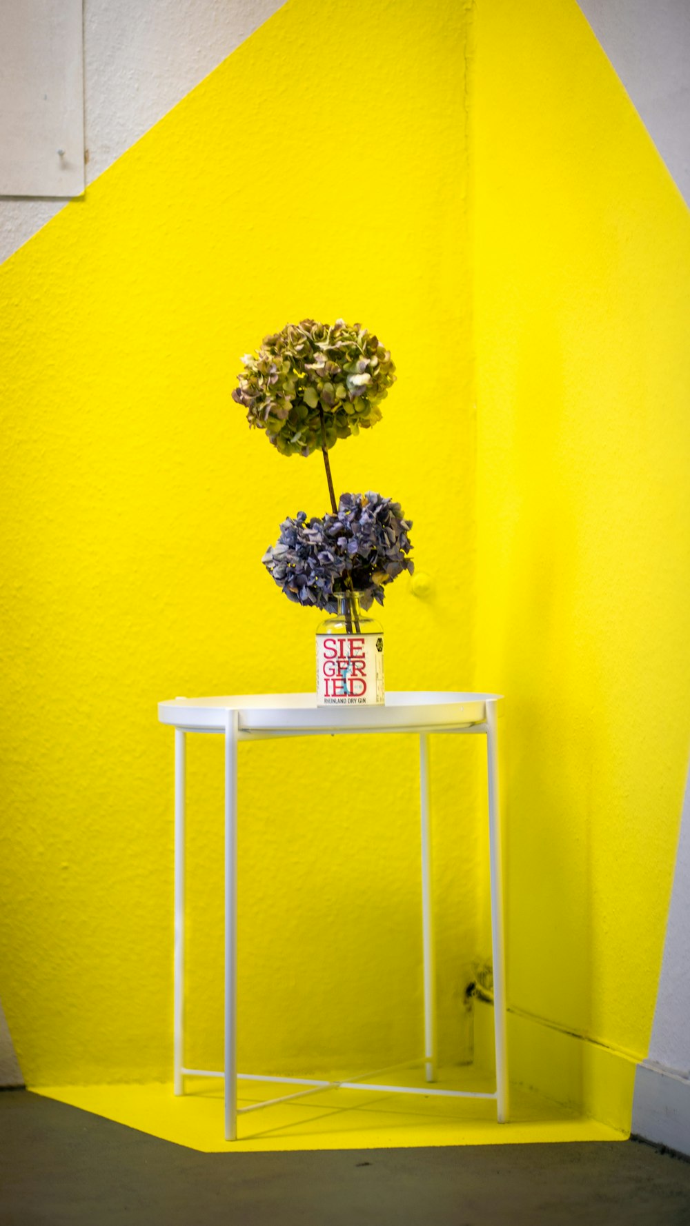 white and yellow flower bouquet on white wooden chair