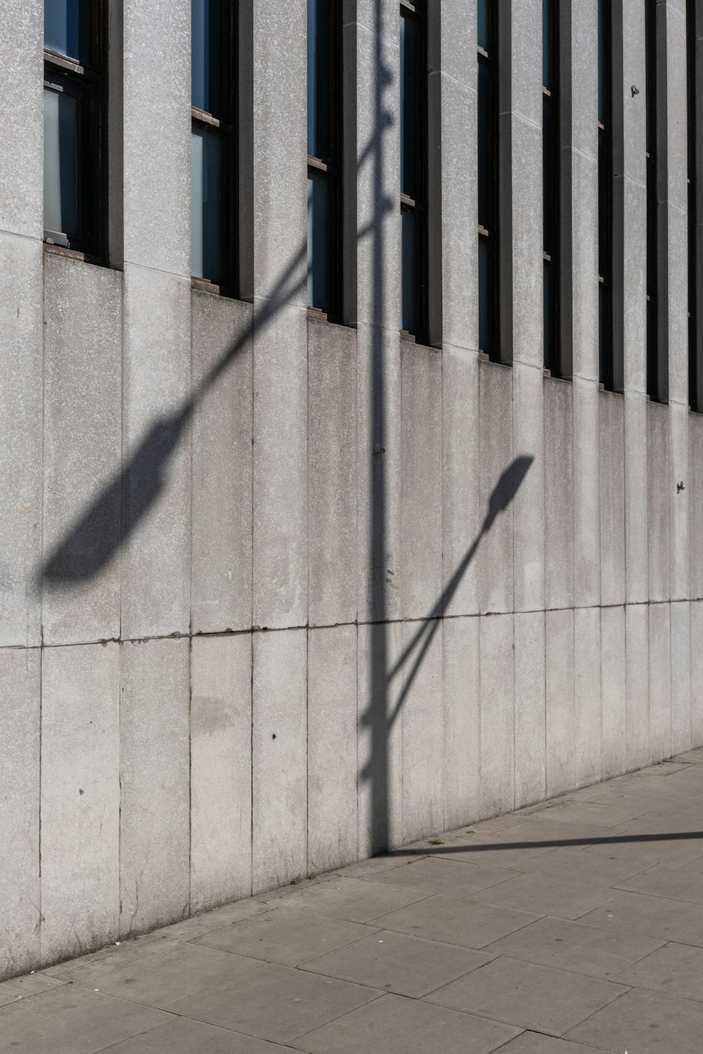 shadow of person on gray concrete wall during daytime