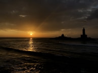silhouette of building on island during sunset