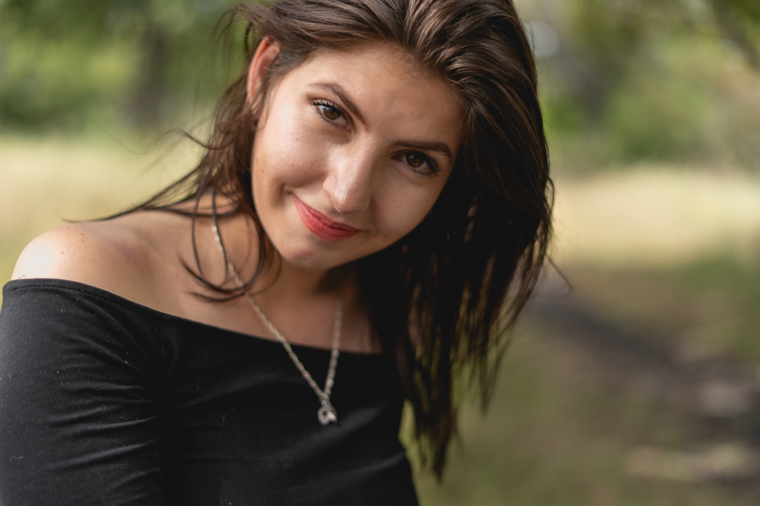 woman in black shirt wearing silver necklace