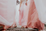 woman in white dress walking on rocky ground during daytime
