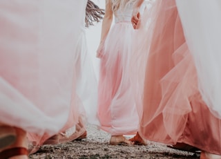 woman in white dress walking on rocky ground during daytime