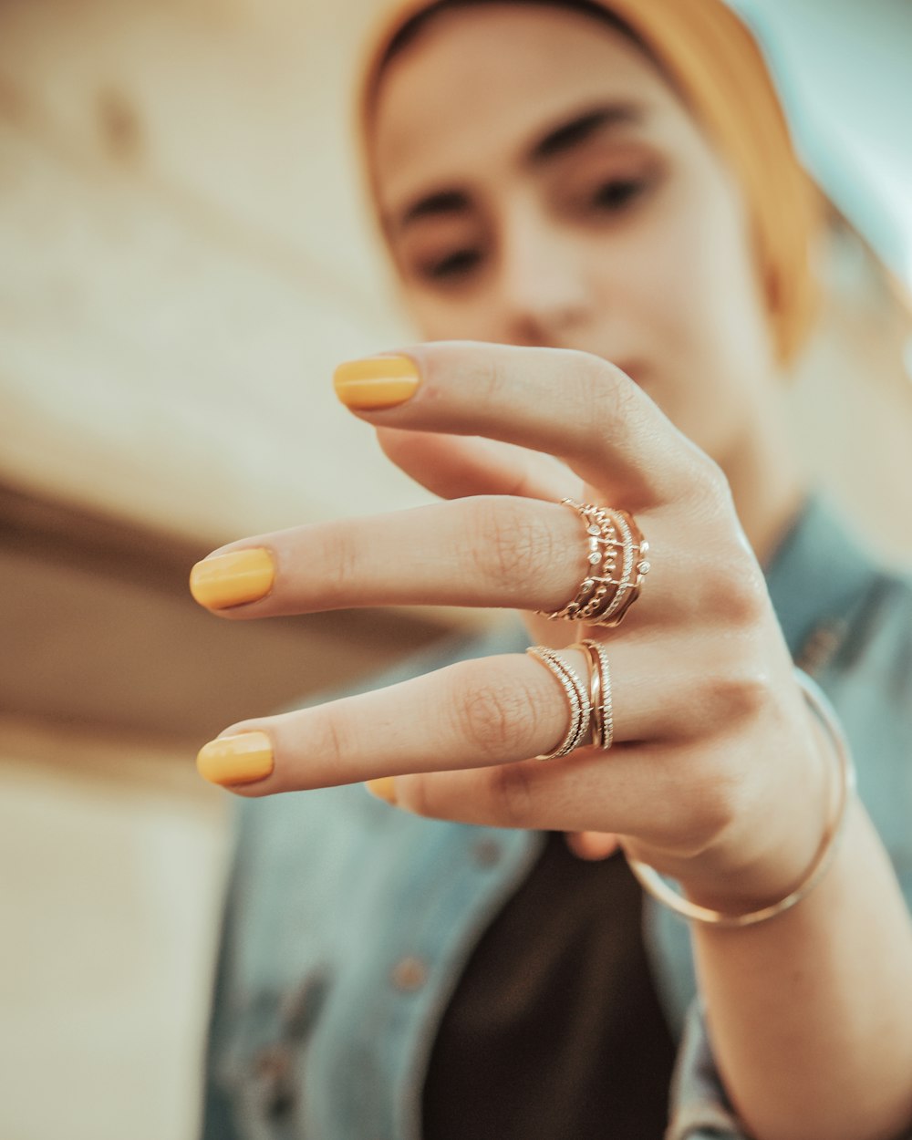 woman wearing gold ring and gold ring