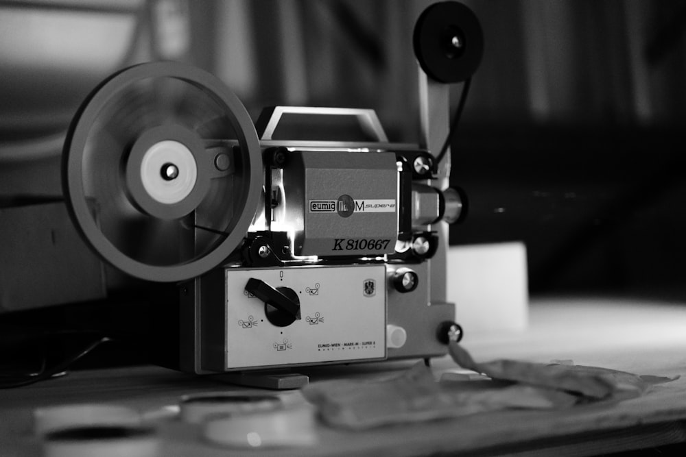 grayscale photo of camera on table